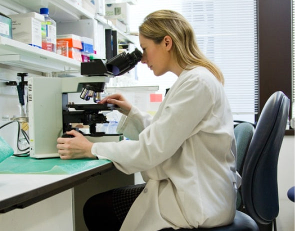 Woman looking through microscope